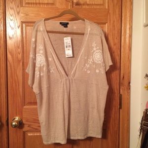 Beige deep v neck top with white floral stitching